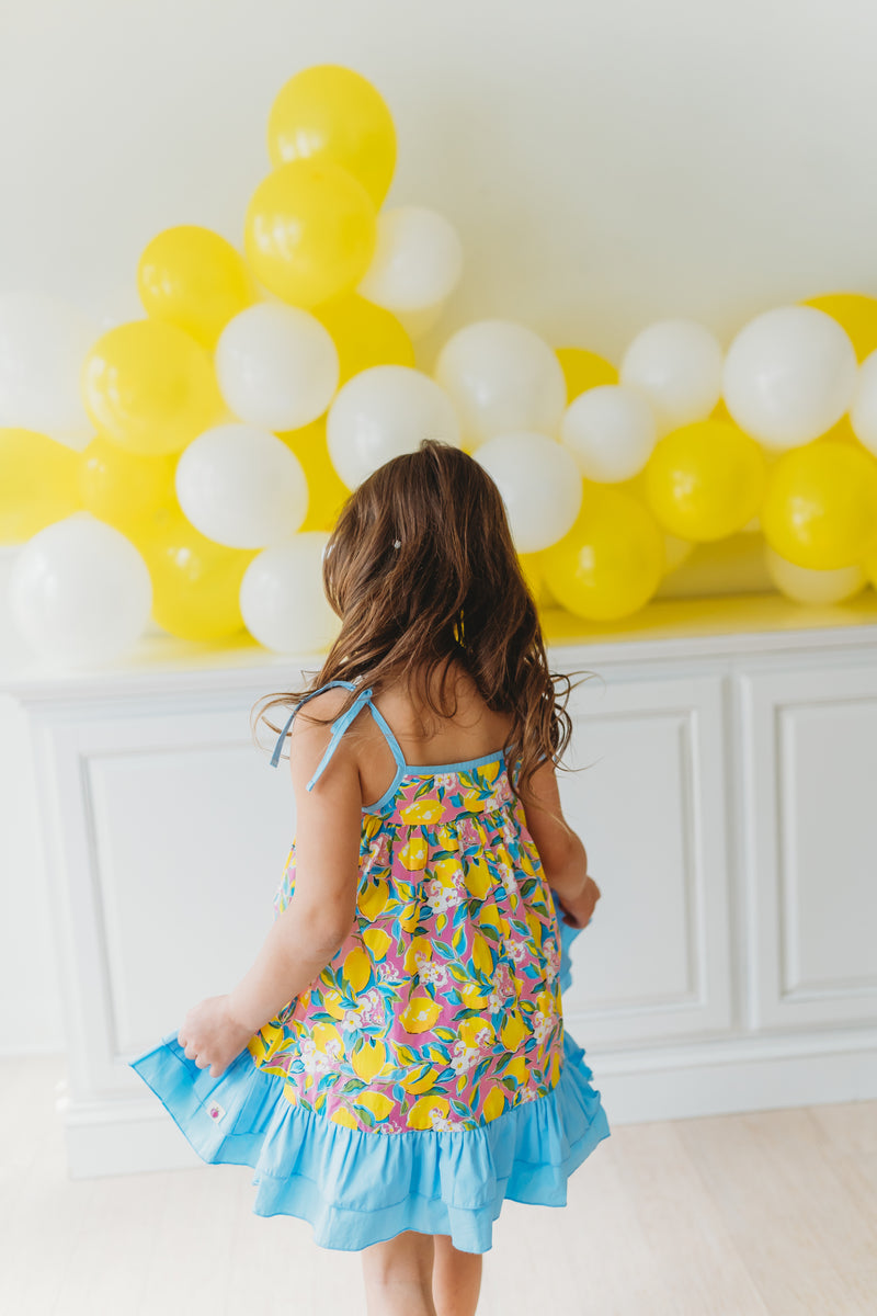 ☀️ Add a twist of zest to her wardrobe with our Stella Lemon Twist Dress!  🌼👗 Don't miss out on the perfect blend of sweet and c